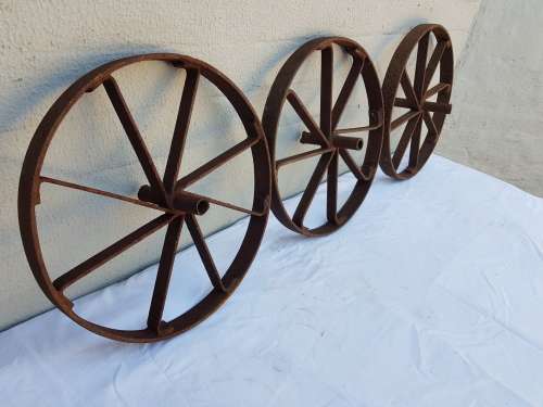 An amazing set of antique 8-spoke steel wagon/ carriage/ cart wheels (1 bid for all 3 wheels)