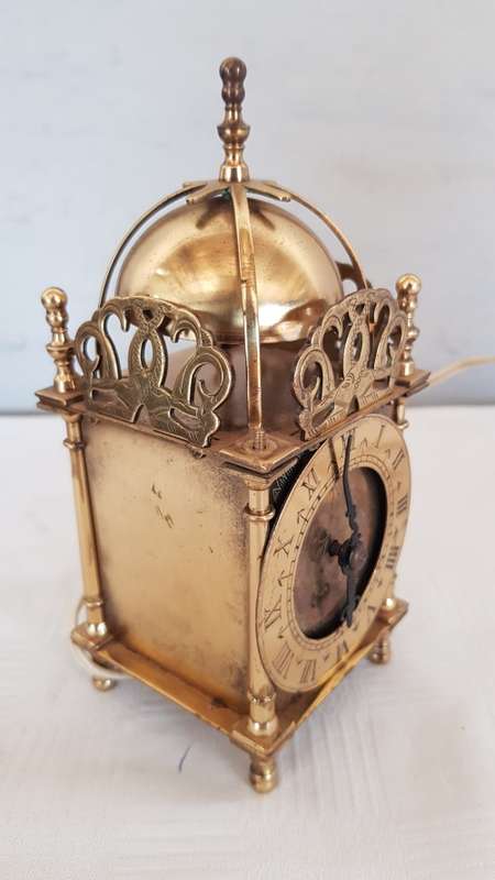 A vintage art deco brass Genelex electric clock