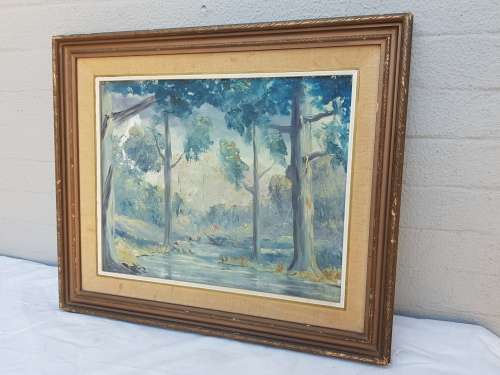 A beautiful framed oil painting of a forrest scene