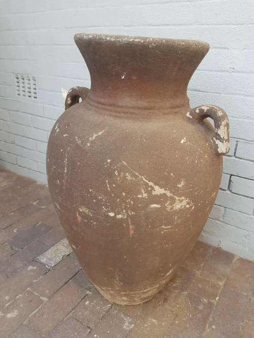 A large concrete free standing outdoor vase. Stunning in a garden!