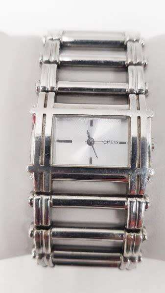 A stunning `GUESS` ladies wrist watch with with a broad strap