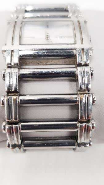 A stunning `GUESS` ladies wrist watch with with a broad strap