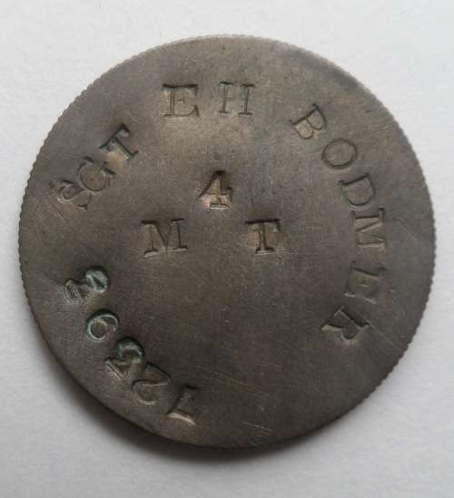 Dog Tag on a 1 Shilling Coin