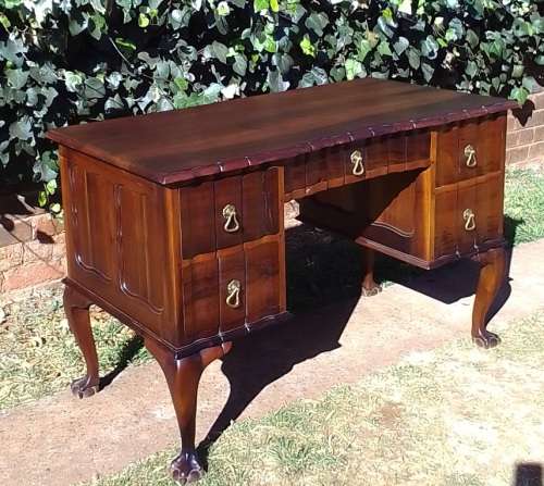 Very pretty, Stinkwood, Ball and Claw desk with five drawers and lovely linnenfold fronts.