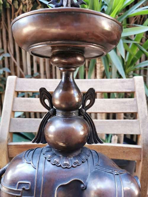 A pair of copper candlesticks crafted in the late 19th century