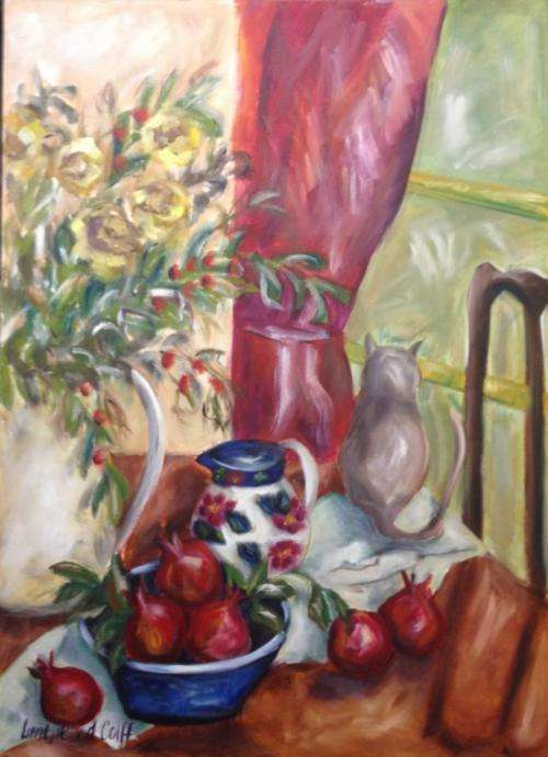 Kitchen table with pomegranates and cat