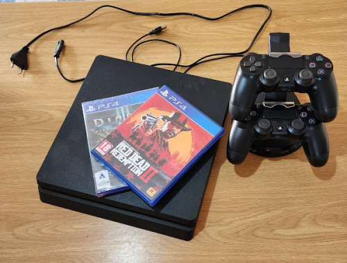 Sony PS4 - Playstation 4 console with 2 controllers, a charging stand and 2 games
