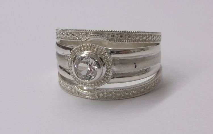 A BEAUTIFUL SOLID STERLING SILVER THREE PIECE WEDDING RING SET WITH FACETED CLEAR STONE...WOW !!!