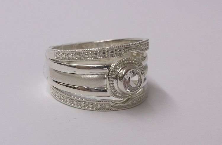 A BEAUTIFUL SOLID STERLING SILVER THREE PIECE WEDDING RING SET WITH FACETED CLEAR STONE...WOW !!!
