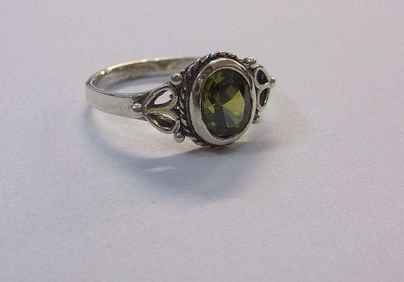 WOW !!! A VERY STYLISH SOLID STERLING SILVER RING SET WITH A FACETED GREEN STONE ....LAST ONE !!!