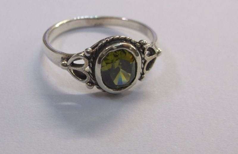 WOW !!! A VERY STYLISH SOLID STERLING SILVER RING SET WITH A FACETED GREEN STONE ....LAST ONE !!!