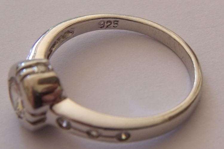 A BEAUTIFUL EXCELLENT QUALITY STERLING SILVER RING SET WITH FACETED STONES...EVEN FACING OUTWARD !!