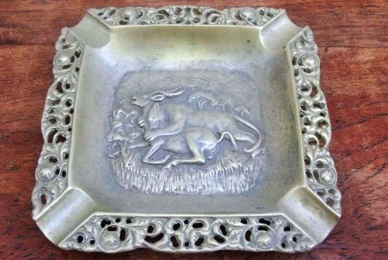 TRULY AFRICAN !! A VINTAGE BRASS ASHTRAY DEPICTING A LIONESS TAKING DOWN A BUCK