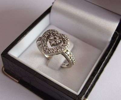 AN UNFORGETTABLE STERLING SILVER RING SET WITH MANY FACETED CZ STONES