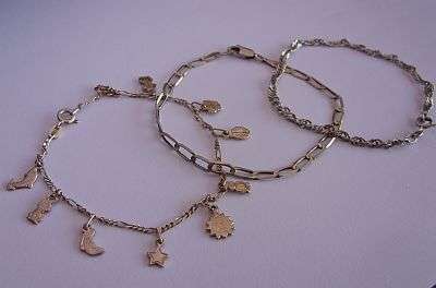 TWO STERLING SILVER BRACELETS & A STERLING SILVER CHARM BRACELET