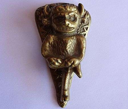 A SOLID BRASS DOOR KNOCKER - DEVILISH FIGURE