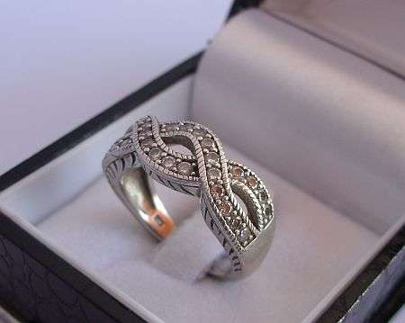 A SENSATIONALLY DESIGNED STERLING SILVER RING SET WITH SUPER FACETED CZ STONES