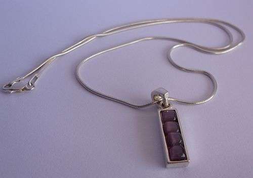 A BREATHTAKING STERLING SILVER NECKLACE WITH STERLING SILVER PENDANT SET WITH CABOCHON AMETHYSTS