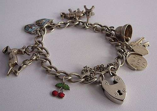 A BRILLIANT SOLID STERLING SILVER VINTAGE CHARM BRACELET WITH 10 AWESOME CHARMS !!!!