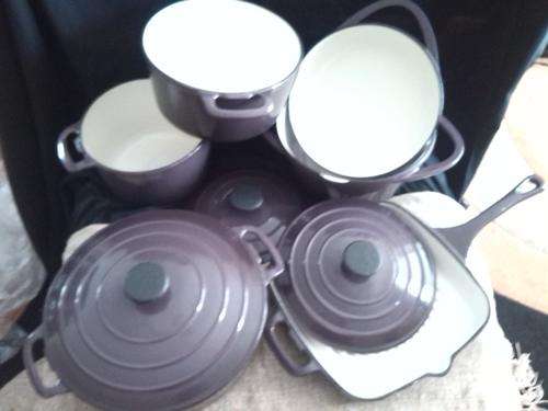 Gorgeous cast iron pot set, purple with enamelled white inside.