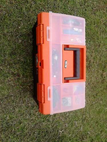 Fishing tackle box with various equipment in