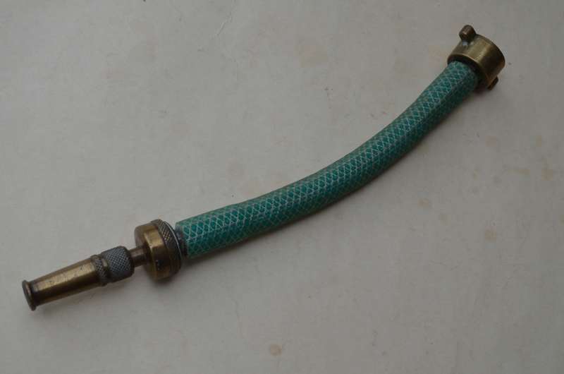 Brass antique hose pipe adjustable cone spray nozzle with the garden tap attachment. A nice prop.