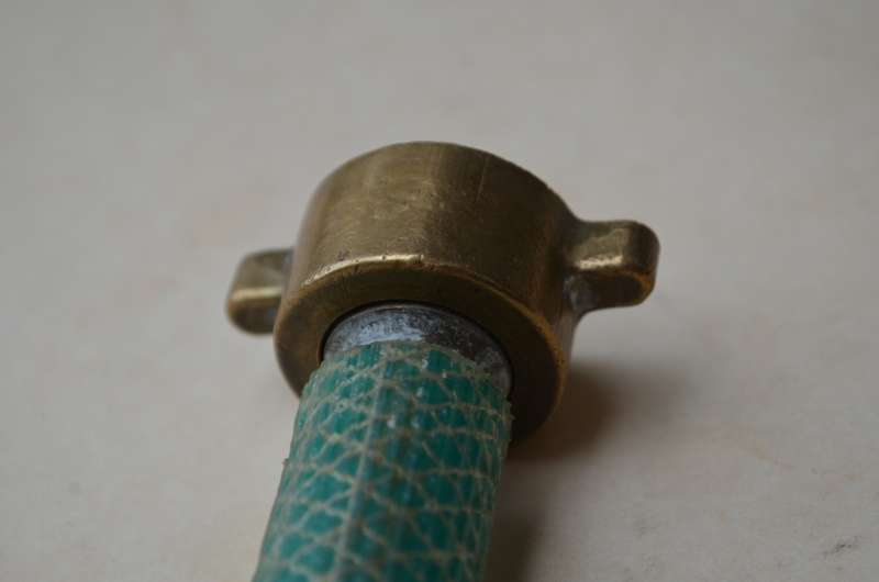 Brass antique hose pipe adjustable cone spray nozzle with the garden tap attachment. A nice prop.