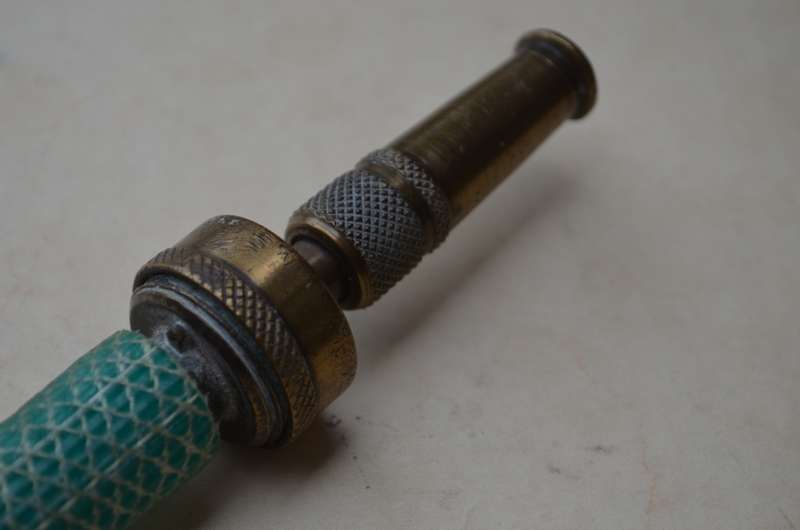 Brass antique hose pipe adjustable cone spray nozzle with the garden tap attachment. A nice prop.