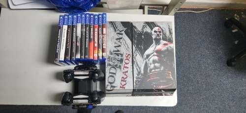 Playstation 4 500GB console with two dualshock controllers, playstation camera and 11 games