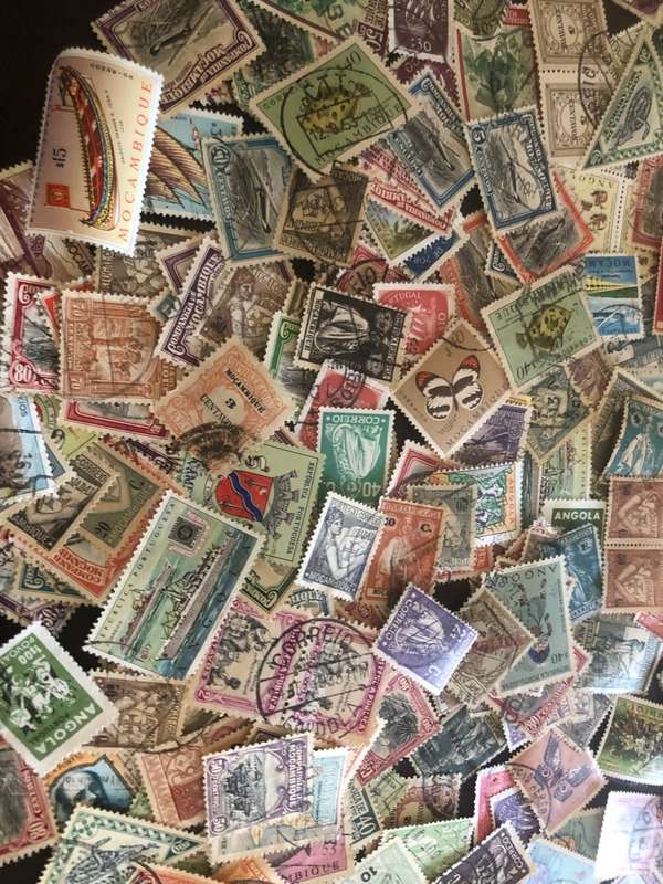 A COUPLE THOUSAND   MOZAMBIQUE   STAMPS OFF PAPER