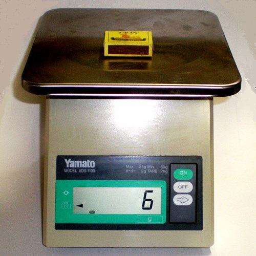 PORTABLE ELECTRONIC DIGITAL SCALE. Yamato model UDS-1100. Weighs up to 2 kg in 2g increments.
