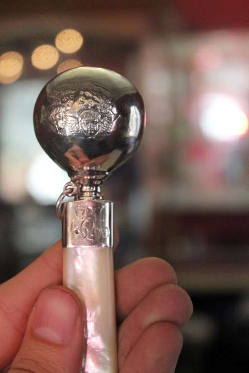Hallmarked Silver Baby Rattle With Mother of Pearl Handle.