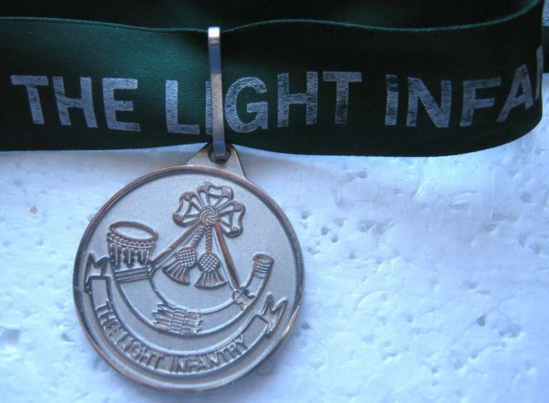THE LIGHT INFANTRY MEDALLION ON A RIBBON IN VERY GOOD CONDITION