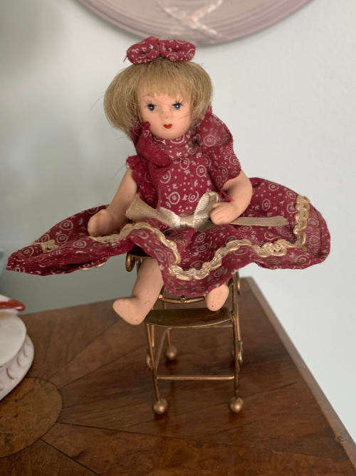 Doll on metal high Chair