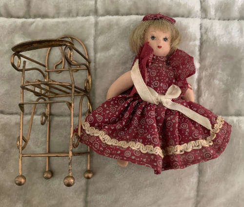 Doll on metal high Chair