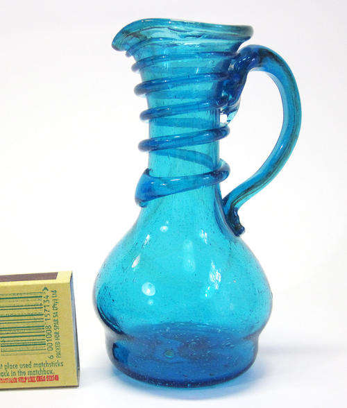 Small handmade ornamental blue glass jug