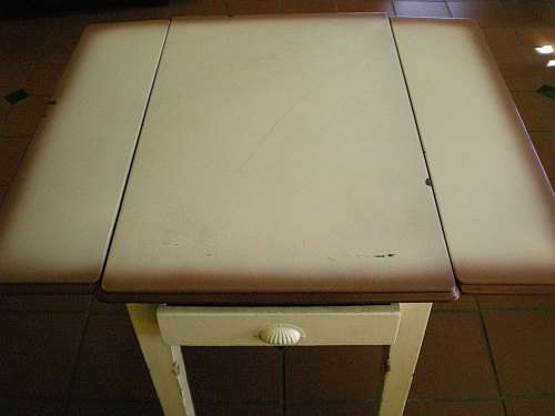 Unique Enamel top table with drop sides and oregon legs.