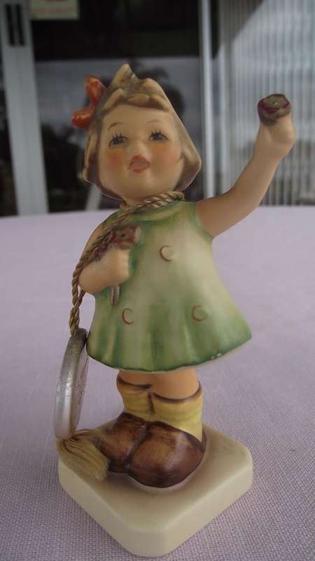 This adorable Hummel is called 'FOREVER YOURS.A tiny rosy-cheeked girl offering flowers
