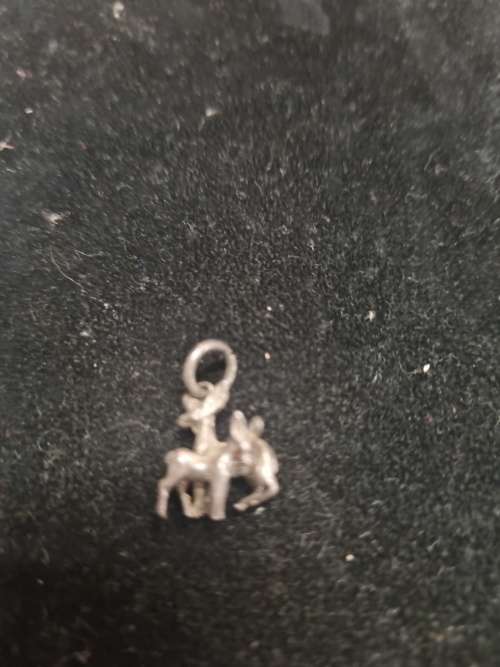 Assorted silver pendants and small silver charms