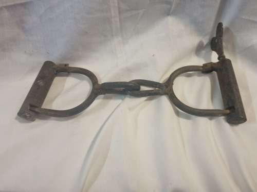 Vintage cast iron hand cuffs with key