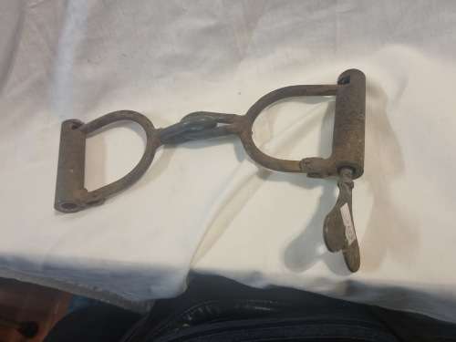Vintage cast iron hand cuffs with key