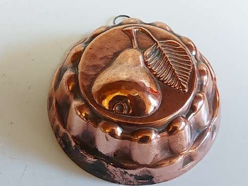 THREE VINTAGE COPPER JELLY MOULDS WITH A FRUIT MOTIF