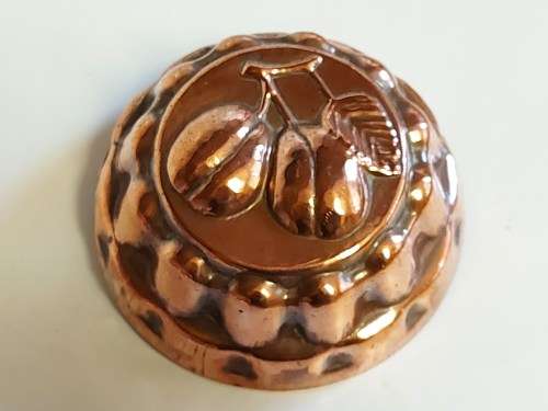 THREE VINTAGE COPPER JELLY MOULDS WITH A FRUIT MOTIF