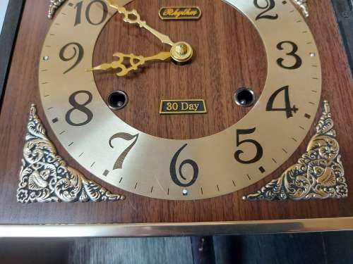 VINTAGE RHYTHM 30 DAY WALL CLOCK IN A WOODEN CASING, WITH KEY AND PENDULUM AND WORKING