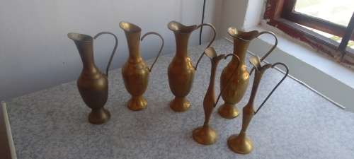 A Collection Of Brass Jugs With Handles