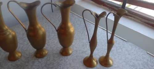 A Collection Of Brass Jugs With Handles