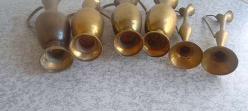 A Collection Of Brass Jugs With Handles