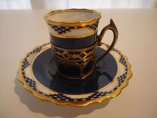 A STUNNING AYNSLEY COFFEE CUP AND SAUCER WITH STERLING SILVER HOLDER
