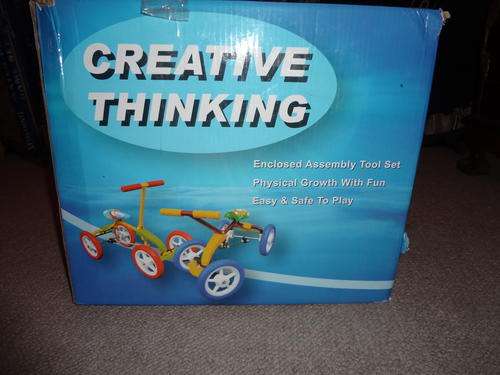 ride on tricycle type with 4 wheels - never used still in box