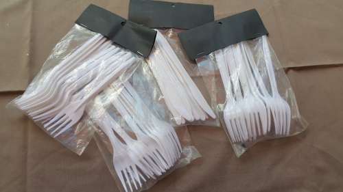 A SET OF NEW WHITE DISPOSABLE PLASTIC KNIVES AND FORKS!!!!